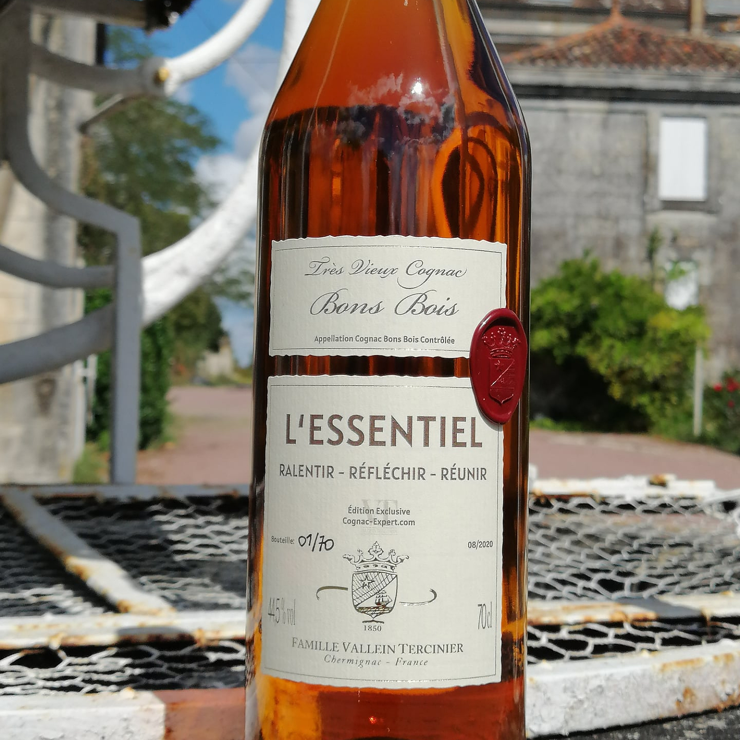 Bottle of L'Essentiel with the chateau in the background