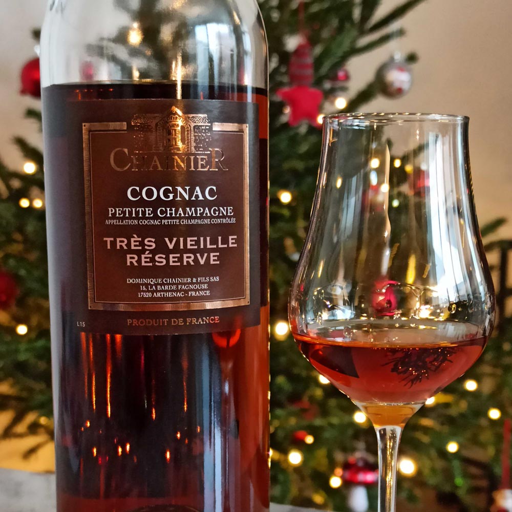 Chainier Tres Vieille Reserve bottle and glass in front of Christmas tree